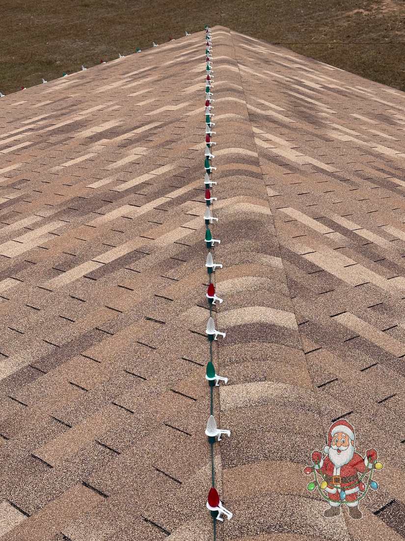 Red, white, and green C9 lights neatly clipped along a roof ridge