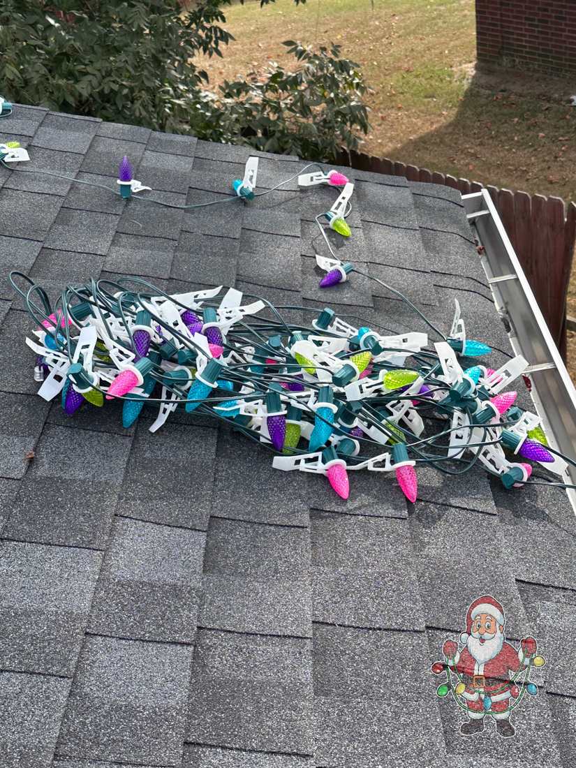 Custom C9 Christmas lights with professional clips ready for install on a shingle roof