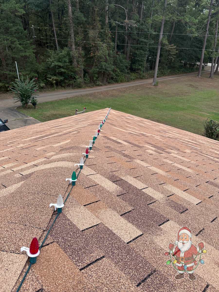 Multicolor C9 Christmas lights installed along a roof ridge